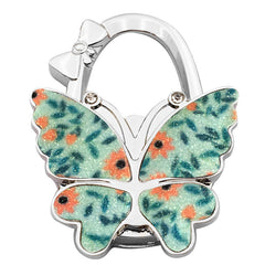 🦋👜【Compra uno y llévate otro gratis】Gancho plegable para bolso con forma de mariposa colorida