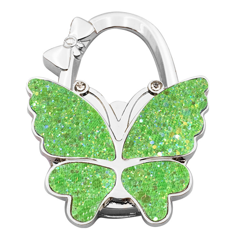 🦋👜【Compra uno y llévate otro gratis】Gancho plegable para bolso con forma de mariposa colorida